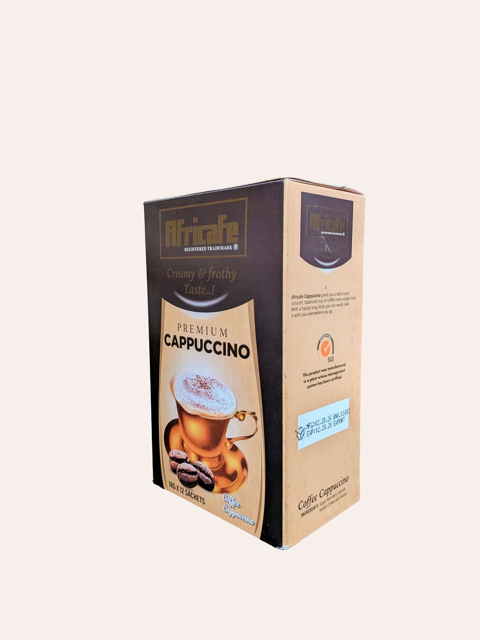 Africafe Premium Cappuccino — a brown and gold box shown at an angle, marked 'Creamy & frothy Taste' and 'Premium Cappuccino', with a photograph of a frothy cappuccino in a glass and roasted coffee beans; 18g x 12 sachets